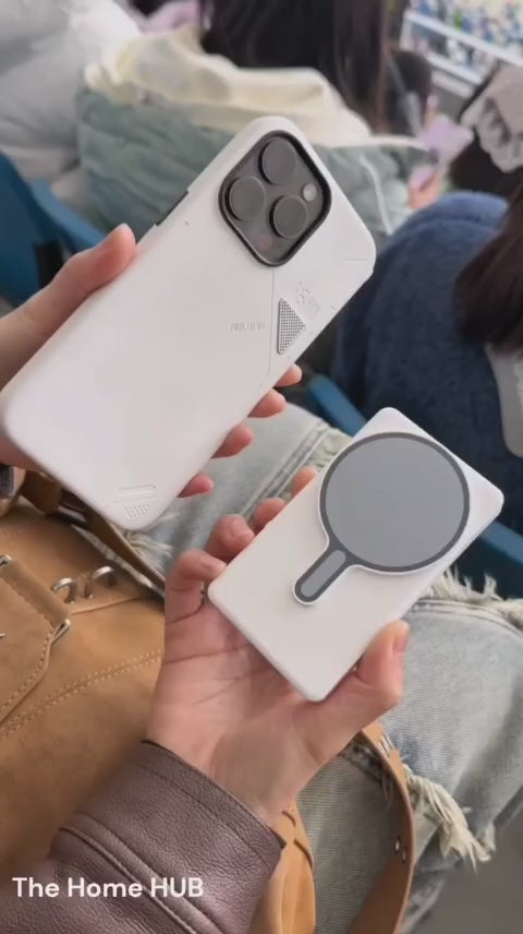 Load video: This video features a stylish young woman in a vibrant, crowded setting casually capturing the moment using the GlamSnap™ Mirror. Attached to the back of her phone, the mirrored screen allows her to see herself while using the phone’s high-quality rear camera. She vlogs effortlessly, adjusting her angle with confidence, showing how easy it is to film yourself with precision — no second guesses, no awkward setups. The moment feels natural, cinematic, and elevated — showcasing the product’s minimalist design and hands-free lifestyle appeal.